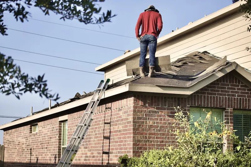 Professional roofer working on a residential roof in Dayville